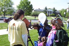 Jeremy supervises as a family looks at the sun.