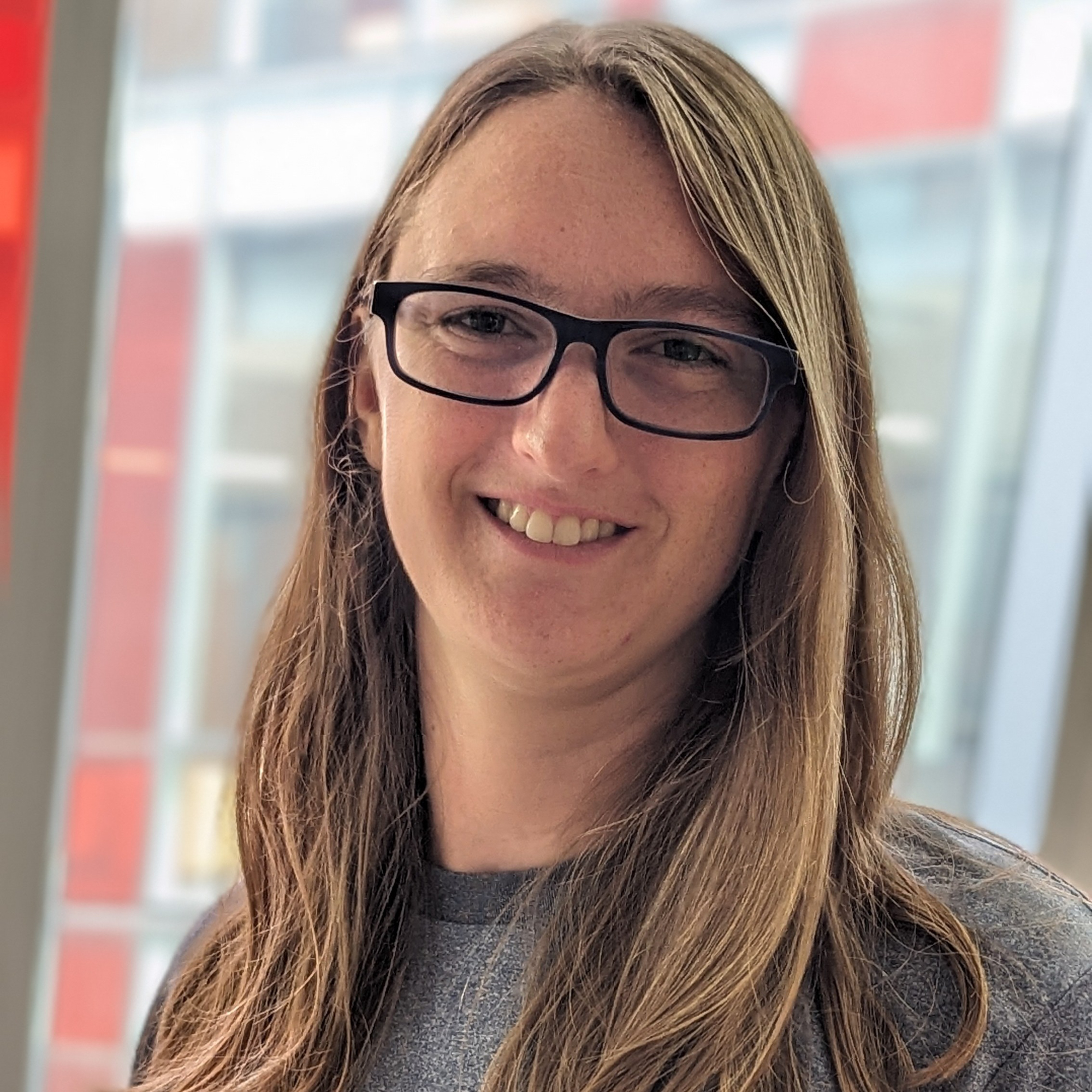 Long blond haired woman wearing glasses