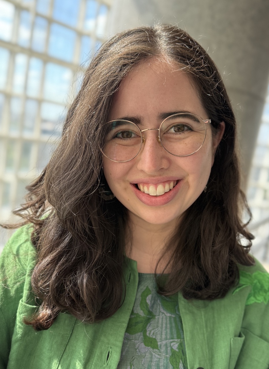 Sophia Sánchez-Maes; young woman, long brown hair, green sweater