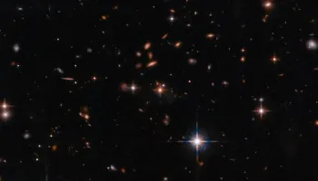 James Webb Space Telescope Uncovers Massive Galaxy Cluster Surrounding a Powerful Red Quasar