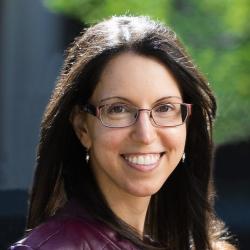 women with long dark hair, glasses, purple jacket