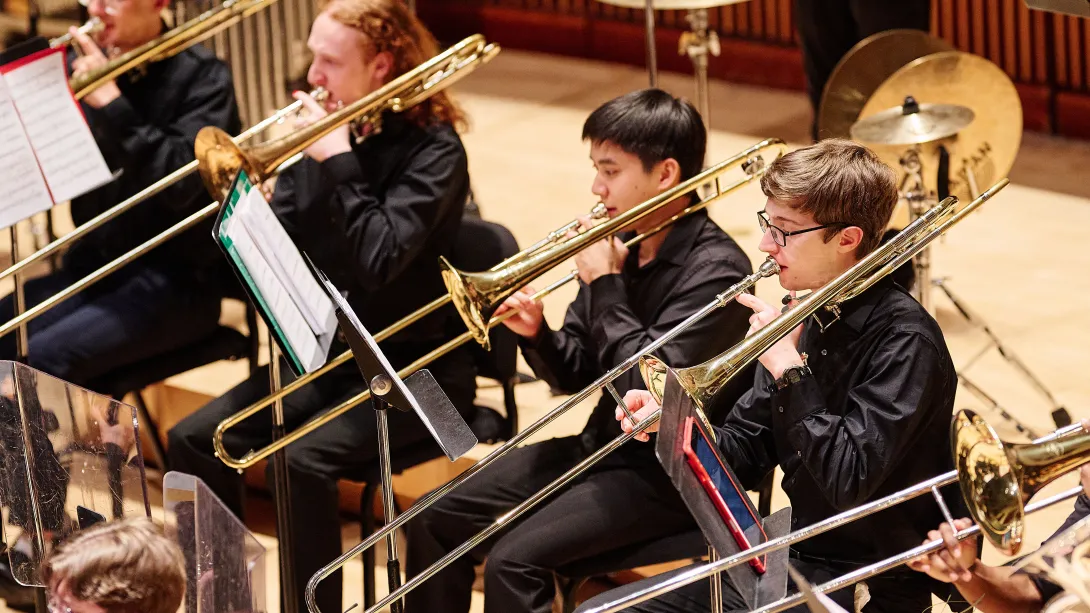 Musicians playing horns in the Gamer Symphony Orchestra.